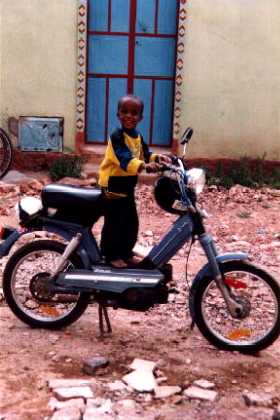 Eritrea - Asmara - Sembel, Nephew of Aster playing with the motorbike of the plumber.