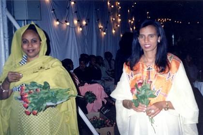 Hostesses handing out red roses at the Asmara Expo party.