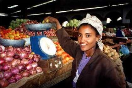 Young Eritrean woman selling vegetables at the market.