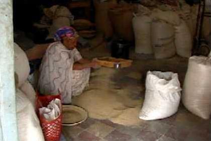 Processing the grain in a little workshop at the Asmara grain markets.