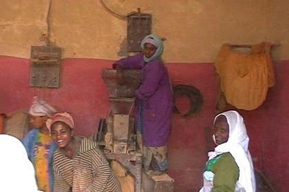 Girls grinding chili in a workshop at the Medeber market in Asmara. The atmosphere in the workshop is filled with a lot of dust.