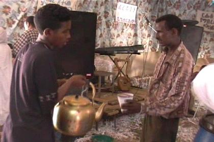 Boys serving "suwa" in big kettles at the wedding in Asmara.