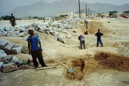 Workers digging grooves for the Keren waterworks.