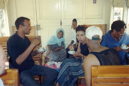 Eritrean coffee being served in the passenger car of the train.