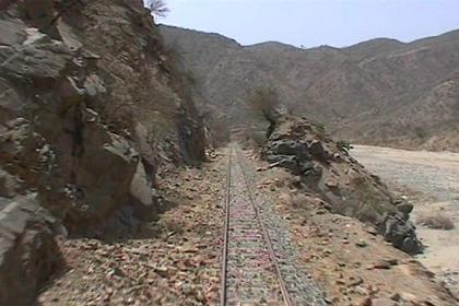 View on the track, sitting behind the bull bars of the train.