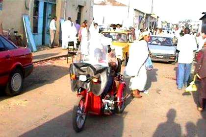 Three wheel motorized bicycle for handicapped ex-soldier.