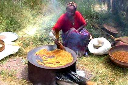 Neighbor of Gorzite and Selamawit roasting atar on the court yard.