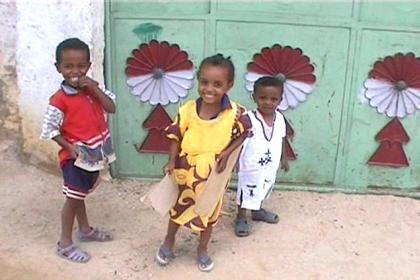 Children in front of their house with decorated doors in Keren.