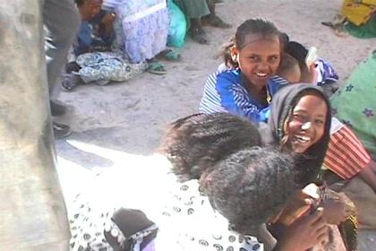 Woman with her children selling vegetables in Adi Keih.