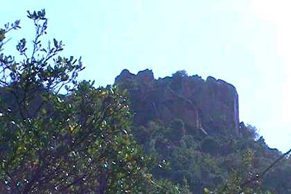 Debre Bizen, barely visible from below in a gap between the boulders at the top.