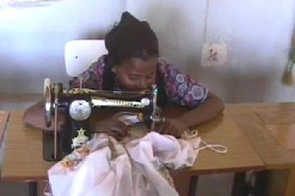 Girl practicing on the sewing-machine at the Dekemhare high school.