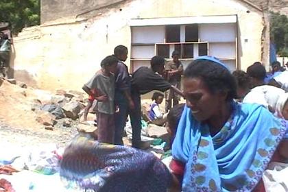 Judging the quality of textile at the market in Ghinda.