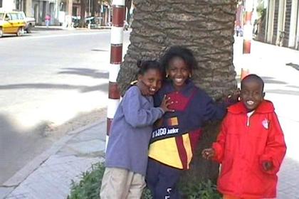 Three children making a show in front of my camera.