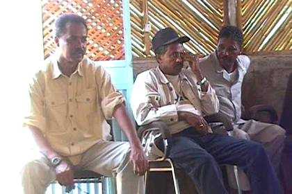 President Isaias Afworki next to two members of the Eritrean government.