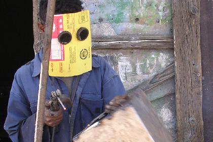 Boy welding - Medeber market Asmara.