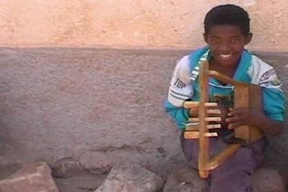 Young boy playing his krar - Acria Asmara.