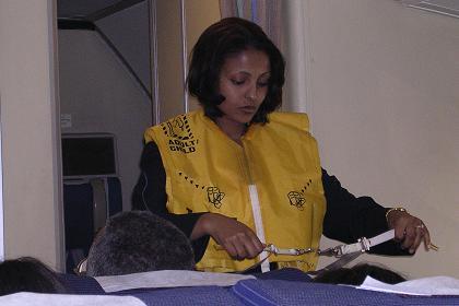 Flight attendant Salem demonstrating the life vests.