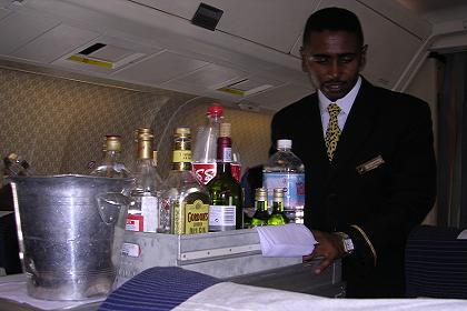 Flight attendant Solomon serving drinks on the flight to Asmara.