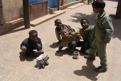 Children decorating the street with little stones - Asmara Eritrea.