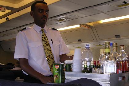 Flight attendant Meron serving drinks on board of the Eritrean Airlines plane.