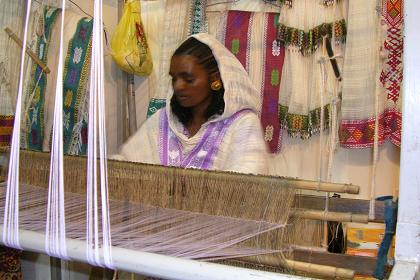 Woman weaving traditional Eritrean womans dresses, zuria -  ETSA exhibition - Expo area Asmara Eritrea.
