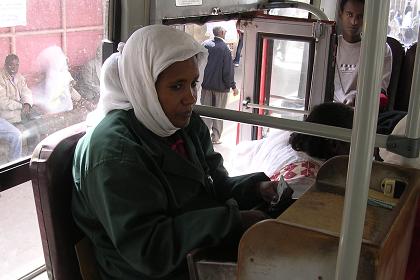 Girl selling tickets in the back of an Asmara bus - Asmara Eritrea.