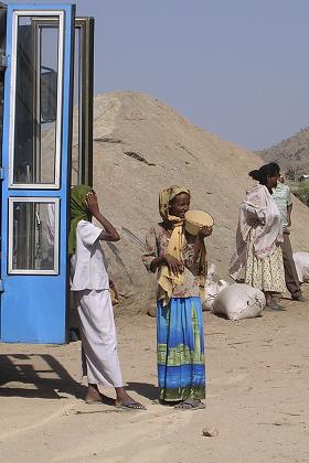 Children selling atar (roasted peas) and foul (peanuts). Tea break at Baluwa (road to Keren) Eritrea.