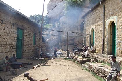 Monks making suwa in an alley of this hilltop village - Debre Bizen Monastery.