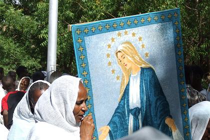Women carrying a banner of the Holy Mary in the procession - Festival of Mariam Dearit - Keren Eritrea.