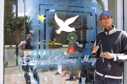 Decorating the shop window - Harnet Avenue Asmara Eritrea.