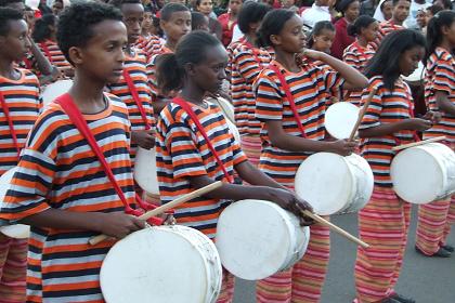 Students of Asmara with matching strip clothes tapping their drums - 17th Independence Day celebrations - Asmara.