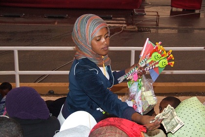 Girl selling candy and flags - Bahti Meskerem grandstand Asmara Eritrea.